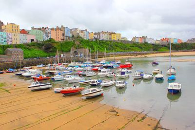 Boats moored at harbor