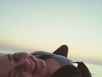 Portrait of smiling man on beach against sky during sunset