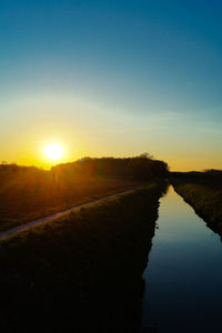 Scenic view of lake at sunset