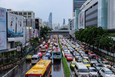 High angle view of traffic on city street amidst buildings