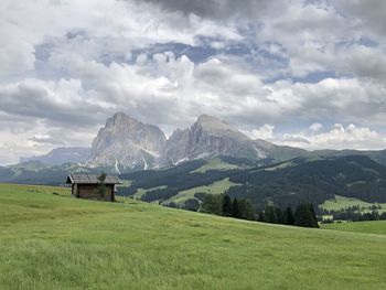 Scenic view of field and mountains against sky