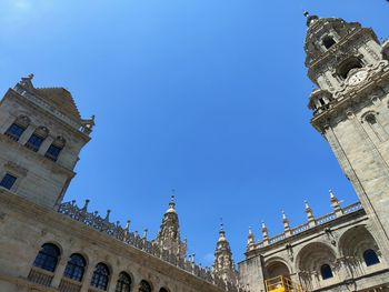 Low angle view of buildings against blue sky
