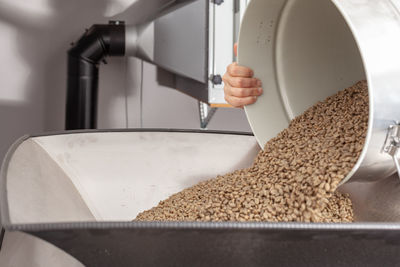 Green beans in the funnel of a coffee roasting machine