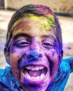 Close-up portrait of boy with face paint during holi