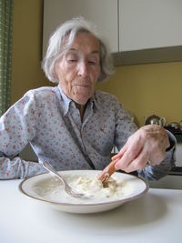 Young woman sitting on table