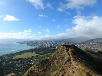 Scenic view of sea and cityscape against sky