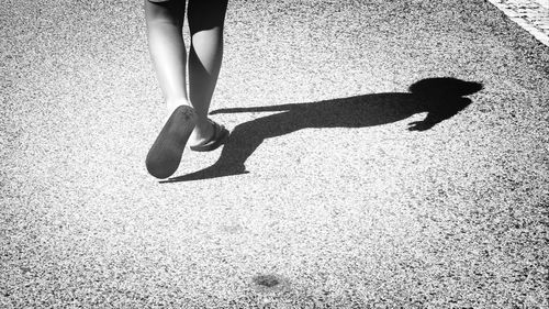 Low section of woman standing on tiled floor