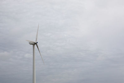 Low angle view of windmill against sky