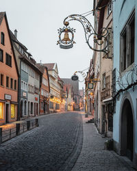 Empty street amidst buildings in city