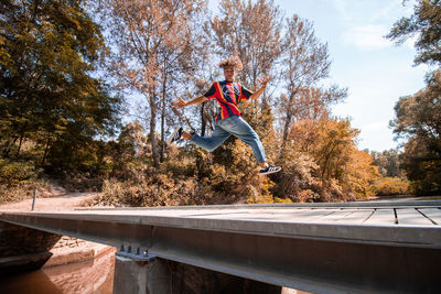 Man jumping in park during autumn