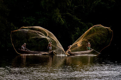 Men fishing by lake