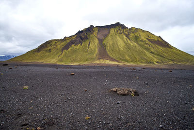 Scenic view of road by mountains against sky