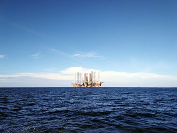 Scenic view of sea against blue sky