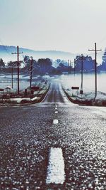 Empty road along trees