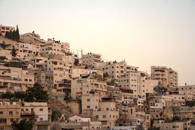 Buildings in city against clear sky