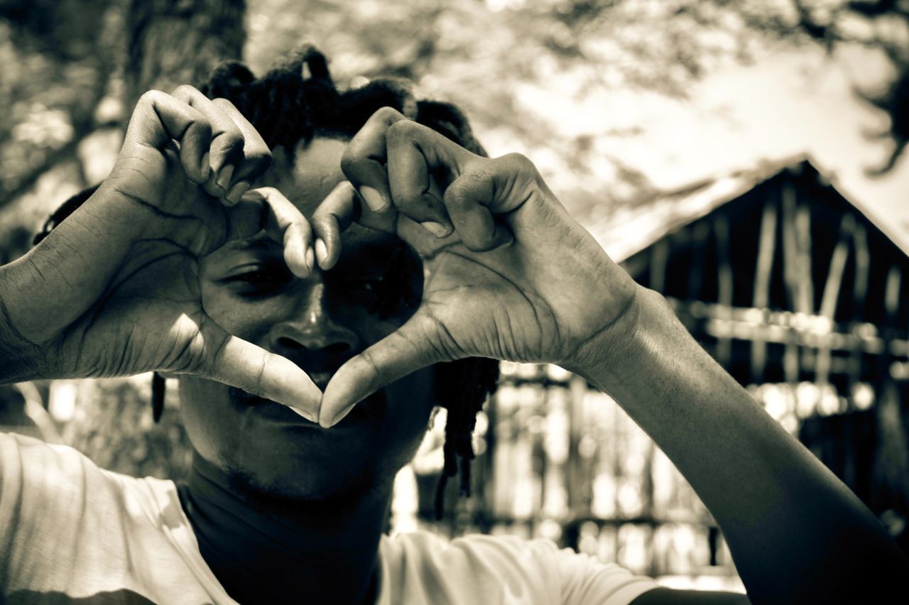 MIDSECTION OF MAN HOLDING HEART SHAPE WITH HANDS