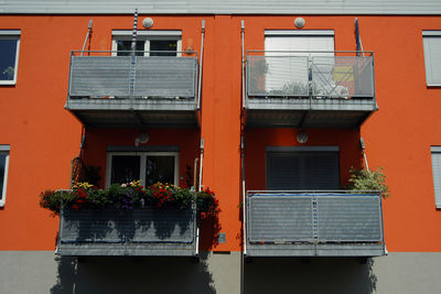 Housing estate in the city, orange apartment block and balconies