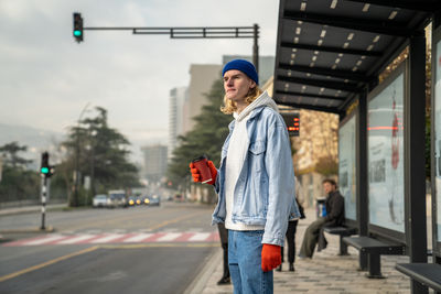 Portrait of young woman standing on street