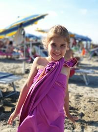 Portrait of a smiling young woman lying on beach