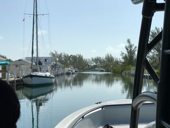 Boats moored on lake against sky