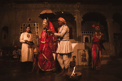 People in traditional clothing performing on stage