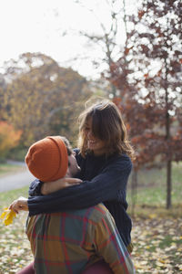 Happy young couple embracing in a park