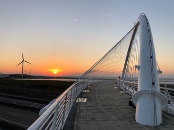 View of suspension bridge against sky during sunset