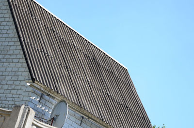 Low angle view of modern building against clear blue sky