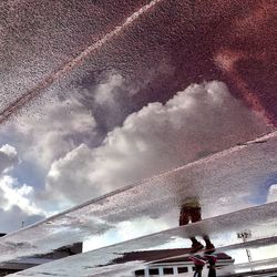 Low angle view of people on snow against sky