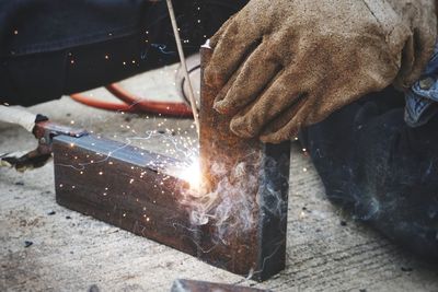 Close-up of male welder welding in factory