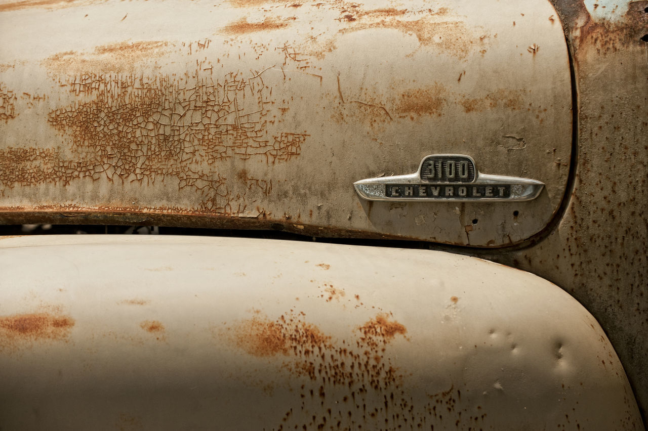 CLOSE-UP OF RUSTY CAR