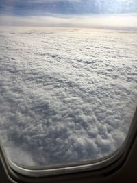 Cropped image of airplane in cloudy sky