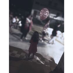 Reflection of woman standing on mirror