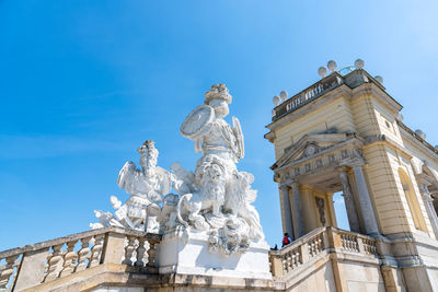 Low angle view of statue against clear blue sky