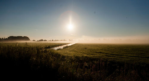 Scenic view of field against sky during sunset