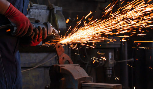 Midsection of man working in factory