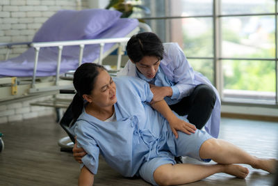 High angle view of mother and daughter sitting at home