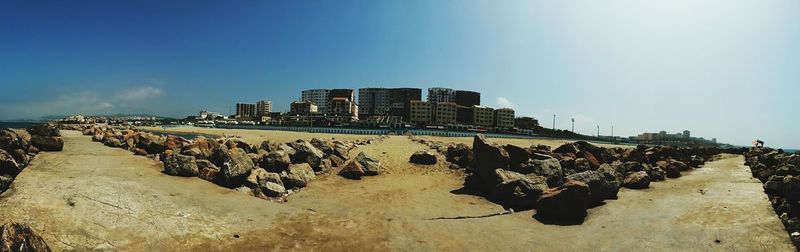 Panoramic view of beach against blue sky