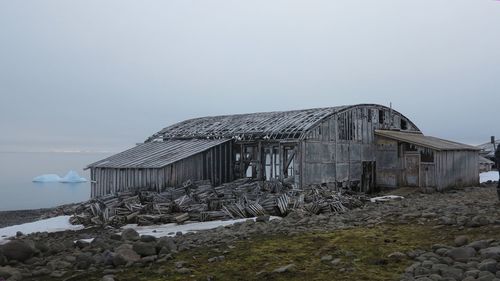 Abandoned building on field against clear sky