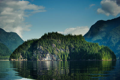 View of lake with cliff and mountains