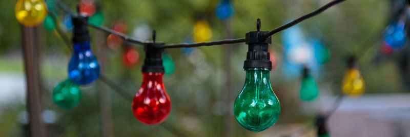 Close-up of multi colored decorations hanging in row