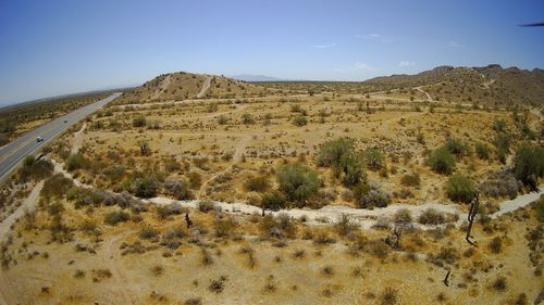 Scenic view of arid landscape against sky