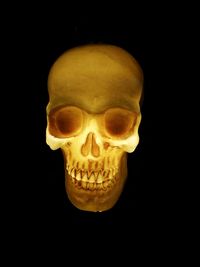 Close-up of human skull against black background