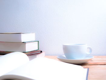 Coffee cup on table against wall