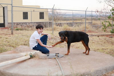 Full length of boy with dog