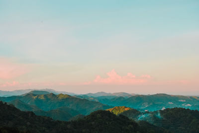 Scenic view of mountain ranges against sky during sunset