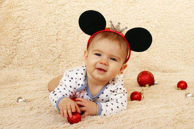 High angle view of girl by decoration on carpet