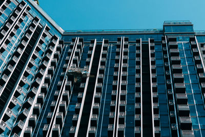 Low angle view of modern building against clear blue sky