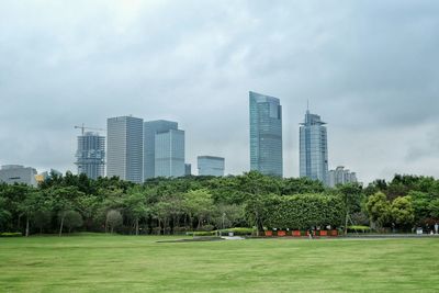 City buildings and park against sky