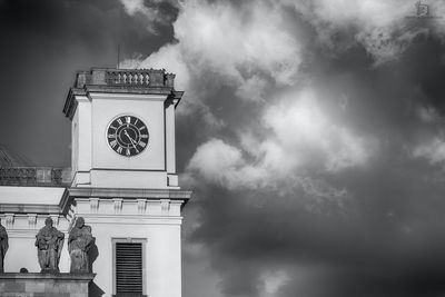 Low angle view of tower against cloudy sky